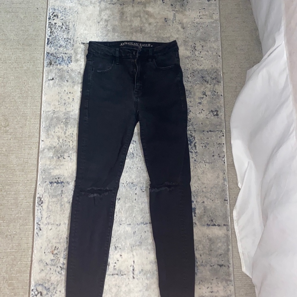 Black jeans with holes in the knees